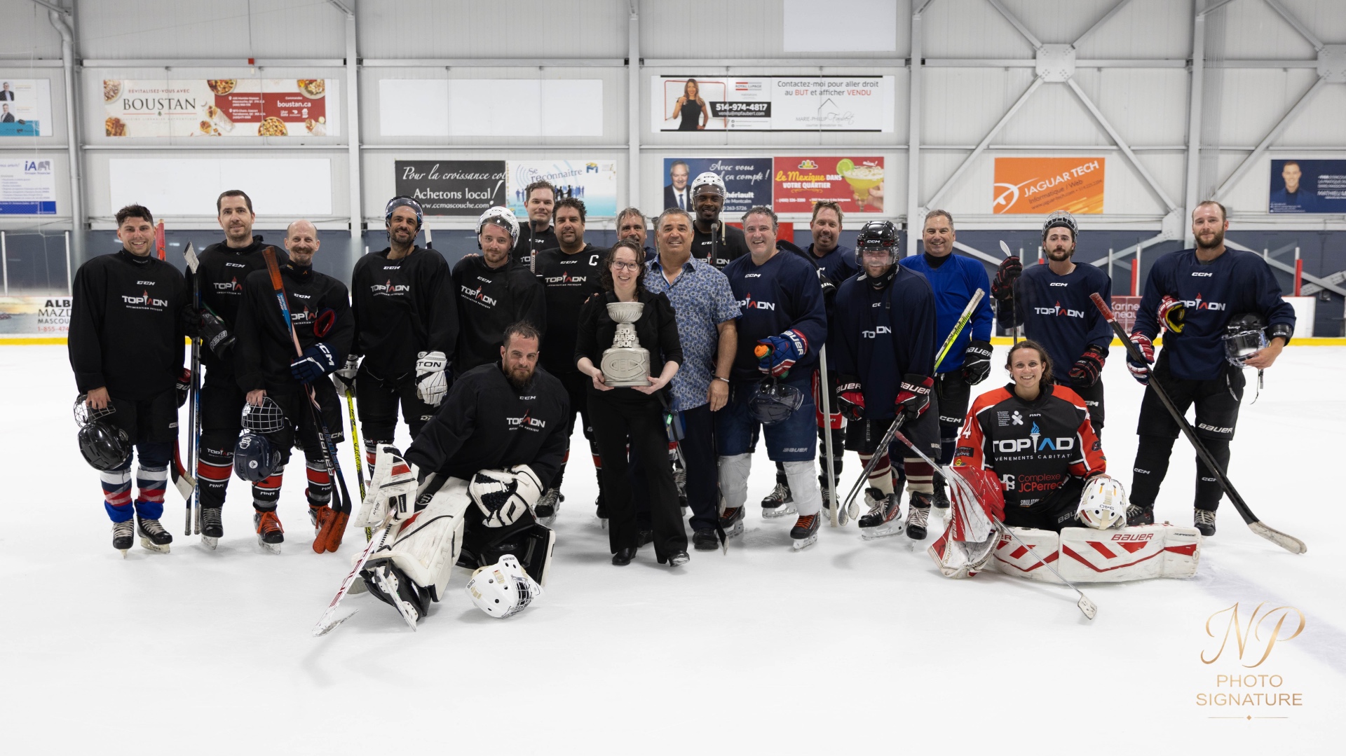 Joueurs et mascotte avec le trophée